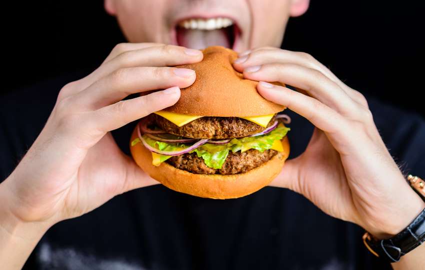 A person eating a burger.