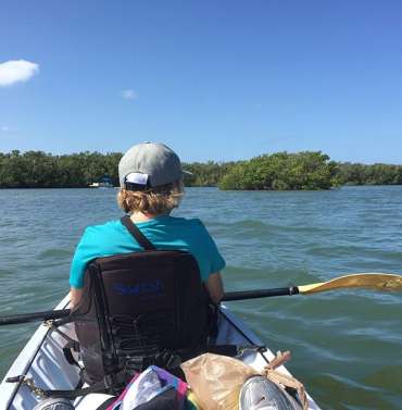 A person kayaking in Estero Bay.