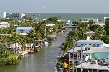 A water way with expensive houses and trees in Fort Myers, Florida