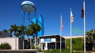 A family-friendly building in Fort Myers featuring a tower and palm trees.