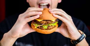 A person eating a burger.